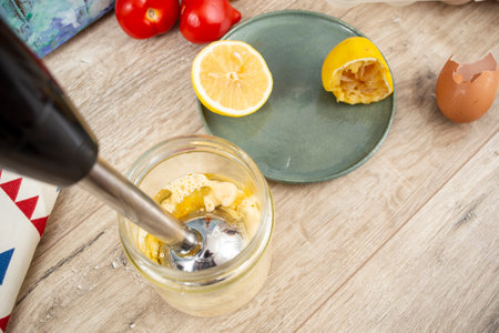 Mayonnaise preparation in a glass jar with a immersion vertical blender,  close up