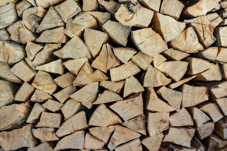 Chopped and stacked fire wood for winter heating, stove fuel storage for cold days, full frame