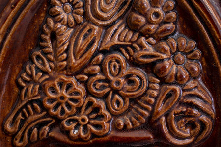 Terra cotta tile on a romanian heating stove, abstract texture, soft focus