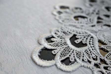 Embroidery pattern on a white table cloth, abstract detailed backgroundの写真素材