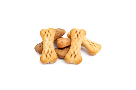 Bone shaped doggy treats pile isolated on white backgroundの写真素材