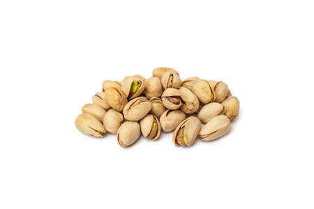Salted pistachio pile isolated on whiteの写真素材
