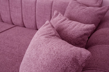 Pink couch detail with three pillowsの写真素材