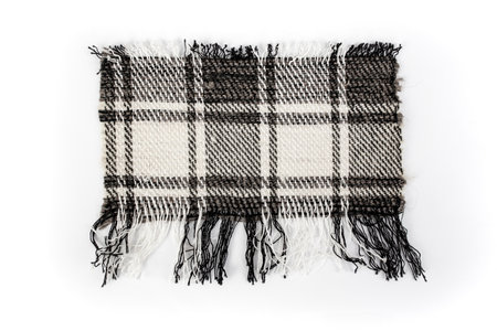 Checkered wool fabric ripped in rectangular shape on whiteの写真素材