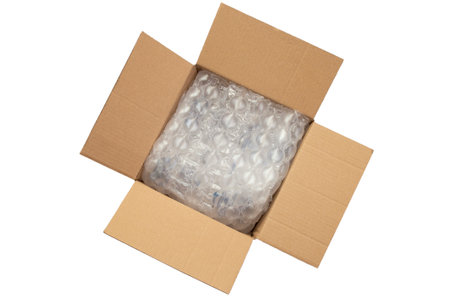 Cushion bubble wrap foil in a opened cardboard box, isolated on whiteの写真素材