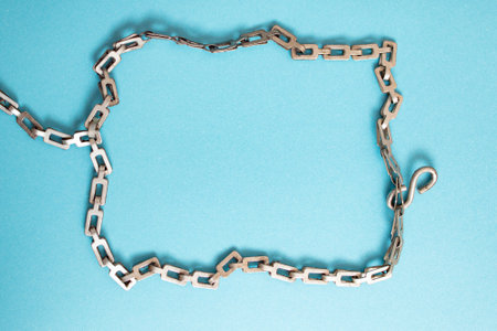 Vintage obsolete link chain rectangle on blue paper background,