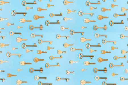 Many golden keys arranged on blue background,  metaphor seamless patternの写真素材