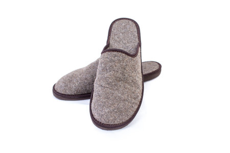 Pair of gray cozy felt slippers isolated on whiteの写真素材