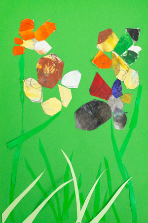 Scattered colorful paper clippings as petals on green cardboard close upの写真素材