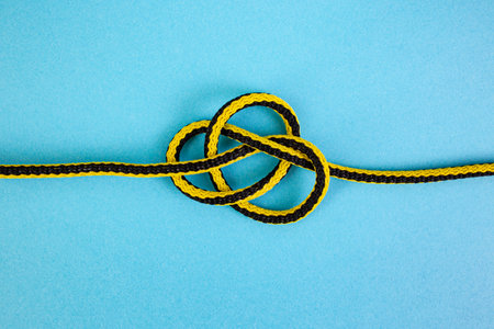 Synthetic cord loose knot explained on blue background