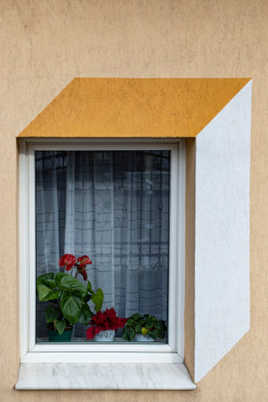 Painted decorative perspective geometric design on a window on a beige wall