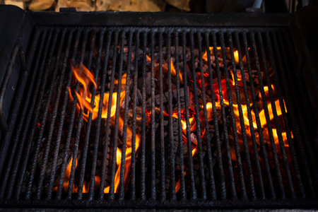 Empty grill with orange flames, abstract  backdropの写真素材