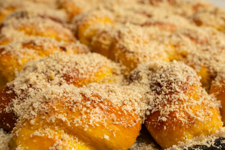 Sprinkling grated nuts on sfintisori .Romanian cuisine. Homemade Mucenici, traditional desserts made...