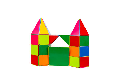 Castle front with gate and high towers made from plastic magnetic tiles isolated on whiteの写真素材