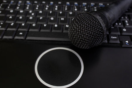 Black microphone and laptop keyboard , soft focus close up, online podcastの写真素材
