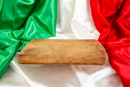 Wooden chopping board floating over colored satin fabric backgroundの写真素材