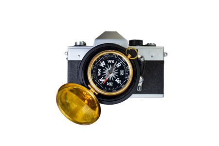 Golden compass on a vintage defocused analog film camera, photography guidance conceptの写真素材