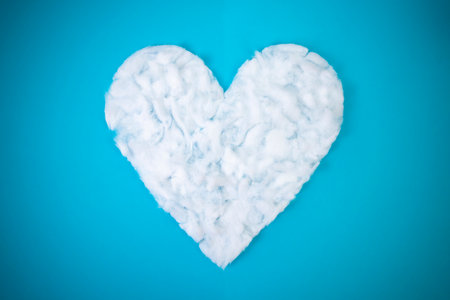 Heart shape cloud, on blue background, abstract textured backdropの写真素材