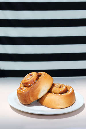 Bun with cinnamon for breakfast in a cafeの写真素材