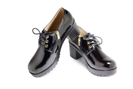 black lacquered shoes on white backgroundの写真素材