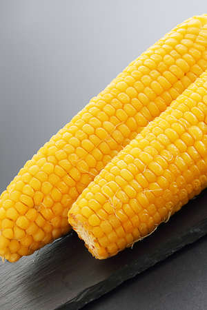 The grilled corn on dark background