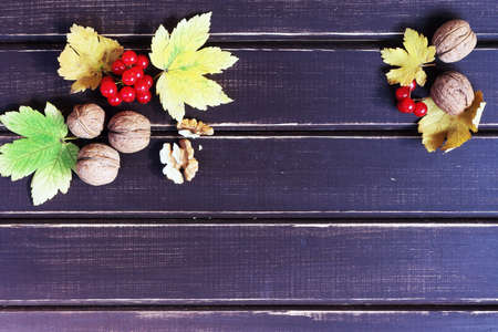 Autumn background on the board with leaves and snowball
