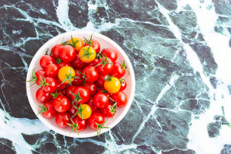 colorful cherry tomatoes for salad on the kitchen tableの写真素材