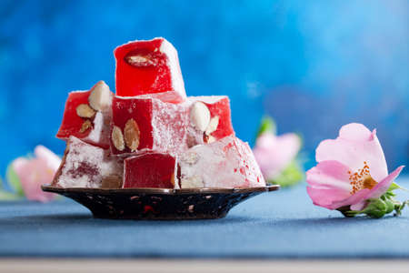 pink Turkish delight, tea and roses on the table
