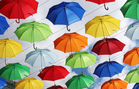 Colorful umbrellas against the backdrop of the autumn sky