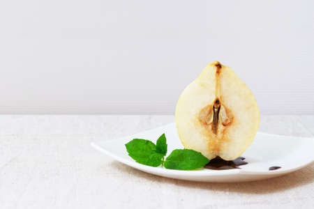 delicatessen pear in chocolate sauce for dessertの写真素材