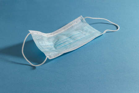 blue face mask on a blue backgroundの写真素材