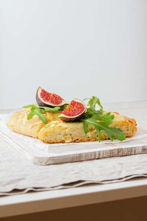 cut into pieces Italian bread with cheese, figs and arugulaの写真素材