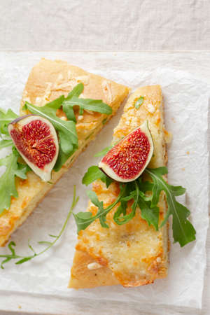 cut into pieces Italian bread with cheese, figs and arugulaの写真素材