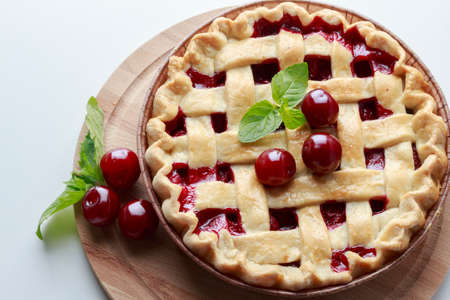 classic cherry pie on a white tableの写真素材