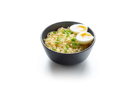 instant noodles with vegetables and eggs in a plate on the table