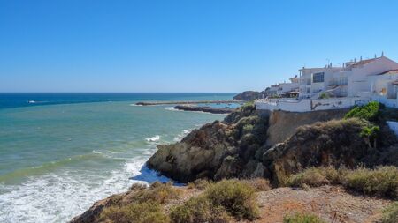 Albufeira, Algarve is a beautiful place with white houses and amazing rocks and ocean. Portugal south. It is a popular resort because of ancient white houses and beautiful rocks.の写真素材