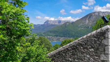 Amazing views of Annecy, beautiful ancient resort in France. Nice and good houses, blue lake and green fantastic mountains around, Alpes.の写真素材