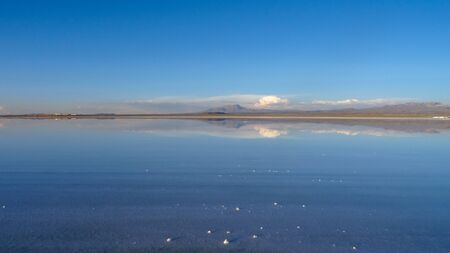 Panoramic photo of bolivian Salar de Uyuni, amazing place in South America. Surface with water makes a mirror.の写真素材