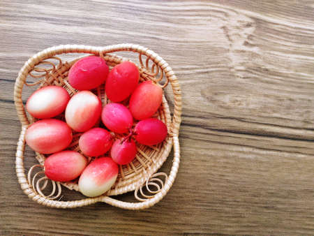 Carunda or Karonda fruit Herb Tropical Fruits Southeast Asia with wood background.の写真素材