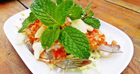 Spicy salad shrimp in fish sauce on wooden background ,  Thai Seafoodの写真素材