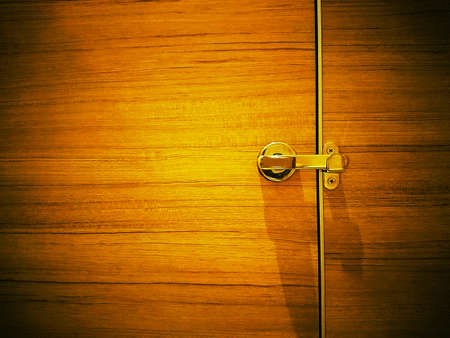 Toilet door latch on wooden textureの写真素材