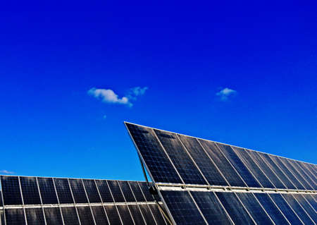 Power plant using Solar panels (solar cell) in solar farm with blue sky and cloud backgroundの写真素材