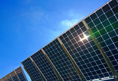 Power plant using Solar panels (solar cell) in solar farm with blue sky and cloud backgroundの写真素材