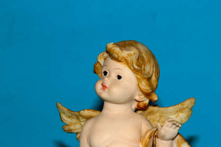 The face of an angel looked into the distance on a blue background. High quality.