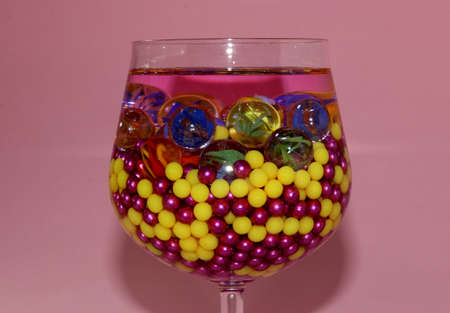 a glass full of colorful balls pink creative