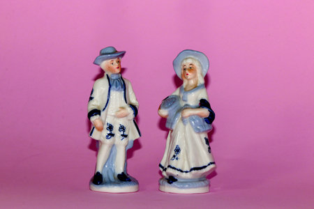 two antique figures on the pink backgraundの写真素材