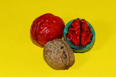 walnut red walnut and green walnut with red nucleus on a yellow background craetiveの写真素材