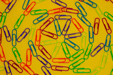 colorful staples on a yellow background creatively arranged beautiful wallpaper