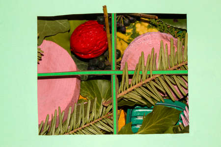 red walnut leaves and pink stumps in a window-like frame around pastel blue wallpaper as copy space,...