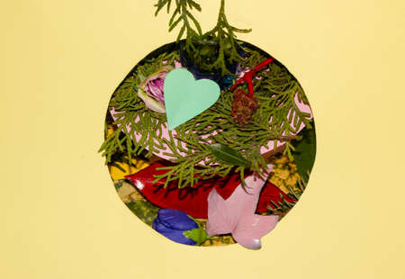 circle with lots of colored leaves and from trees and evergreen trees in a pastel yellow background...